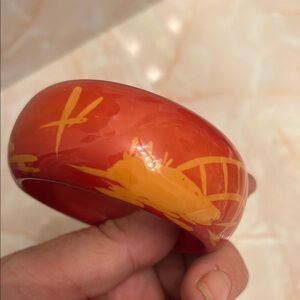 Large thick plastic bangle bracelet with abstract design